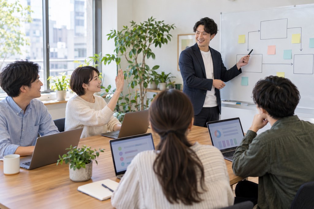 ノートPCを開いて社内AI研修を受ける社員たち